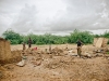 husband-and-wife-with-their-two-children-scavaging-through-the-remains-of-their-home