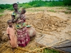 single-mother-with-her-two-children-standing-where-her-front-door-used-to-be