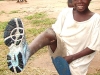 village-boy-puts-on-shoes-for-the-first-time-resized
