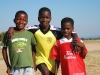 sister-with-brothers-wearing-donated-clothes-from-canada