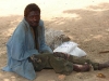 crippled-man-rests-in-the-shade-after-receiving-food