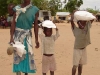 crippled-widow-and-her-children-carry-home-the-gift-of-maize