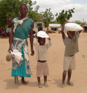 crippled-widow-and-her-children-carry-home-the-gift-of-maize